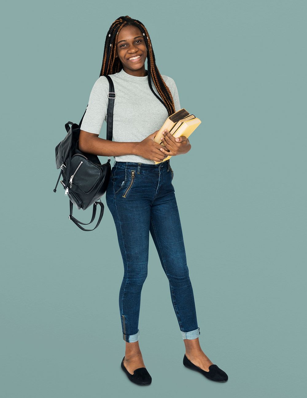 African girl student smiling and holding textbook