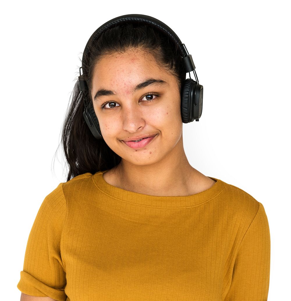 Indian girl smiling and listening music by headphones
