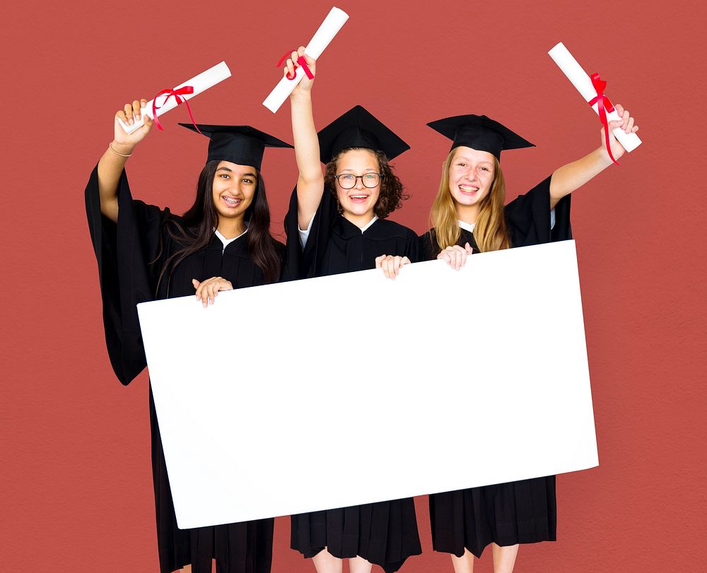Diverse Students wearing Cap and Gown Showing Blank Copy Space Studio Portrait