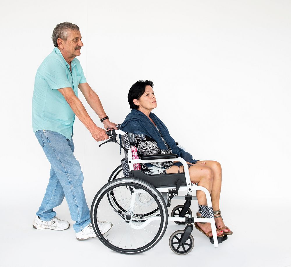 Man and woman sitting on wheelchair