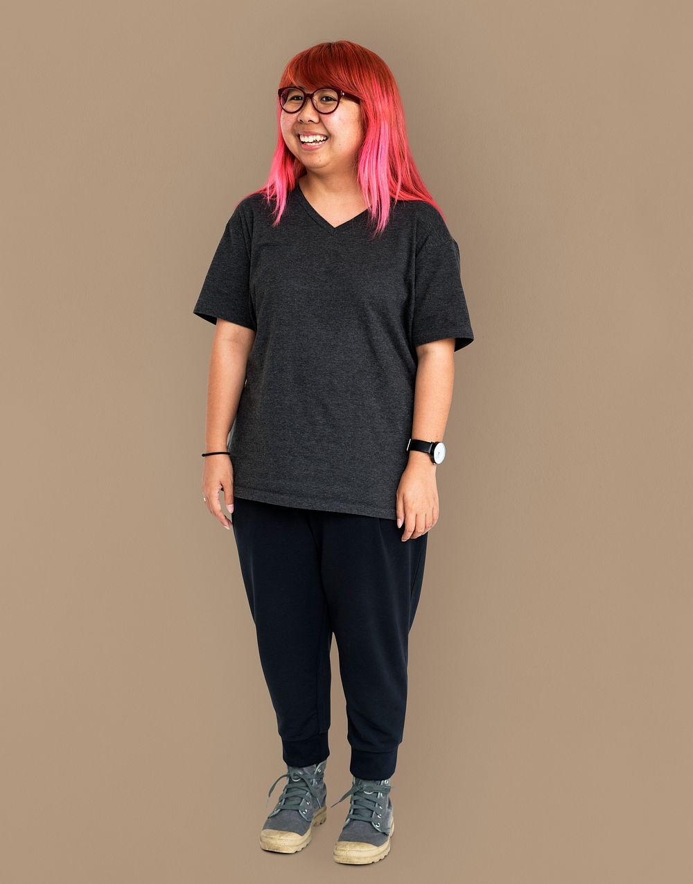 Young adult asian girl standing and smiling studio portrait