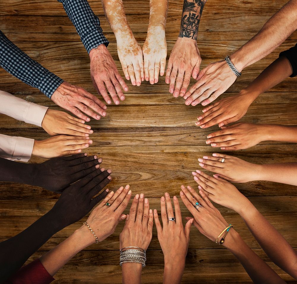 Group of hands assemble in aerial view