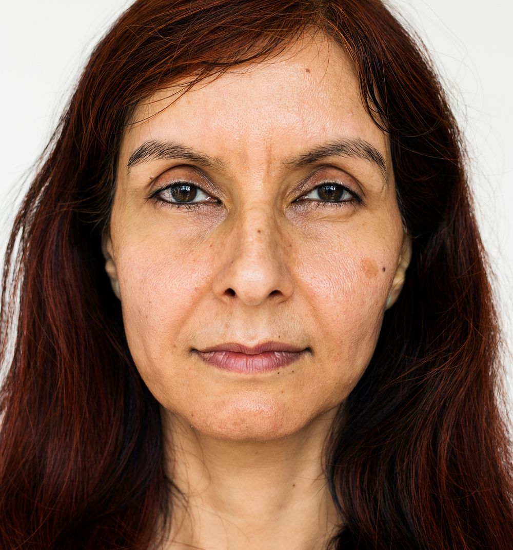 Senior indian woman looking at camera on white background