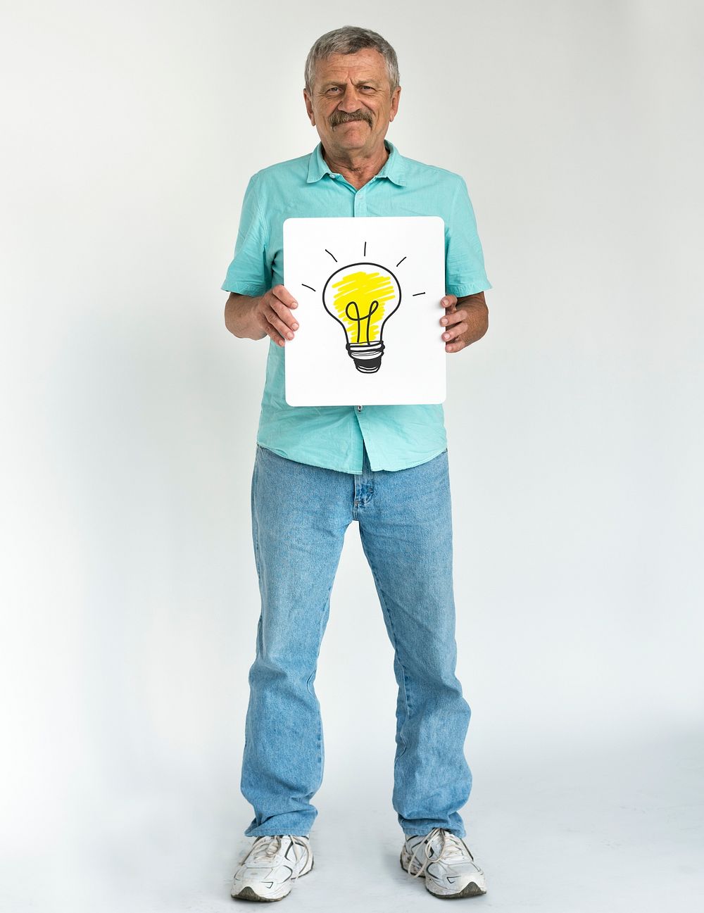 Senior man holding placard lightbulb