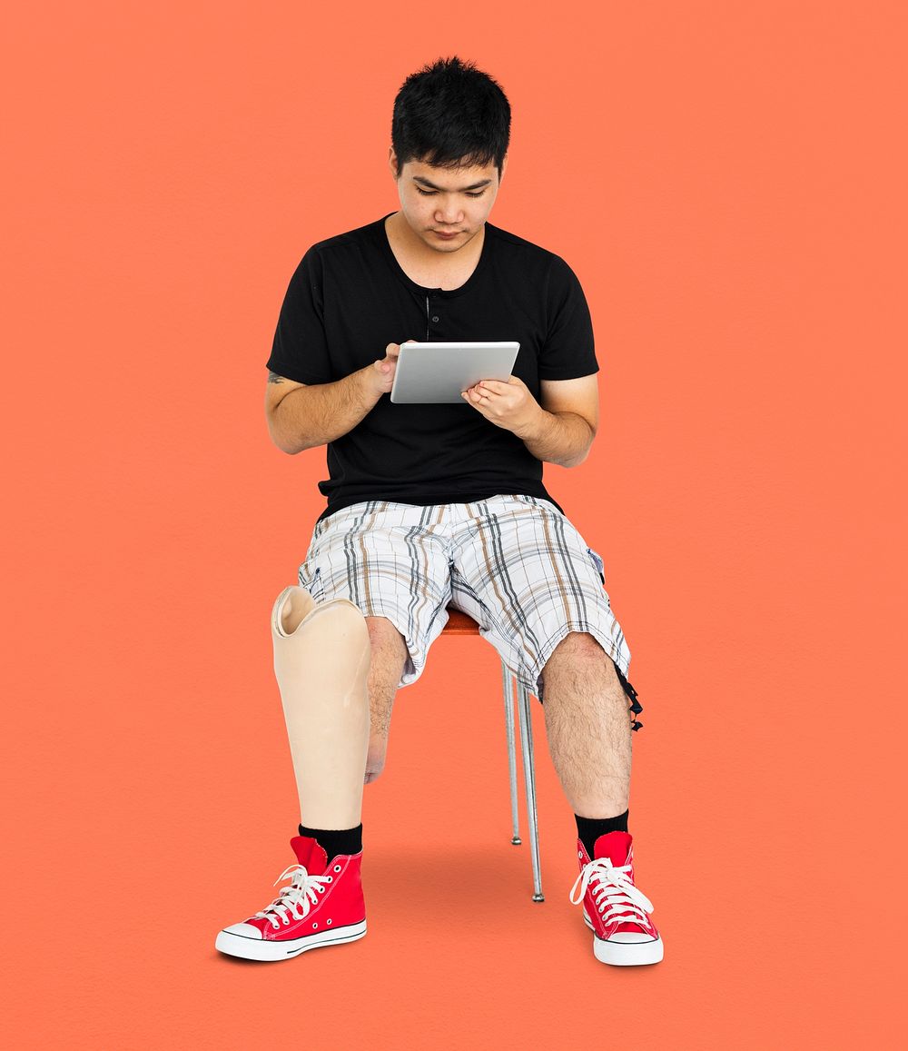 Disability Young Man with Prosthesis Leg Using Tablet Studio Portrait