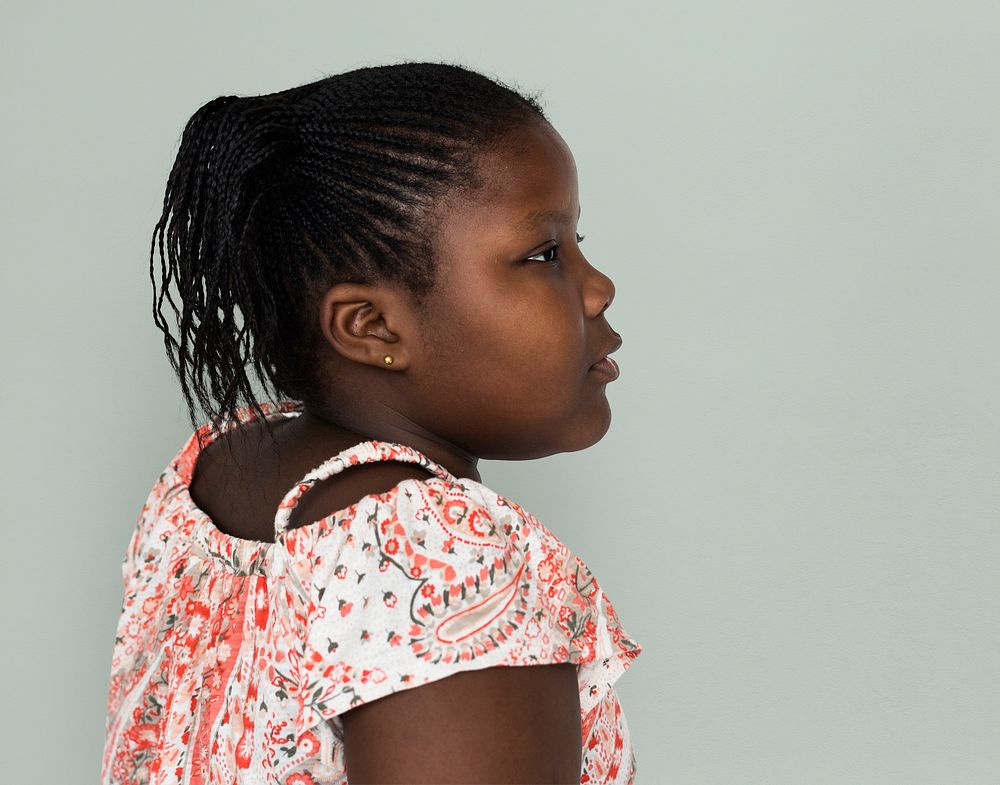 Little african girl casual studio portrait side view
