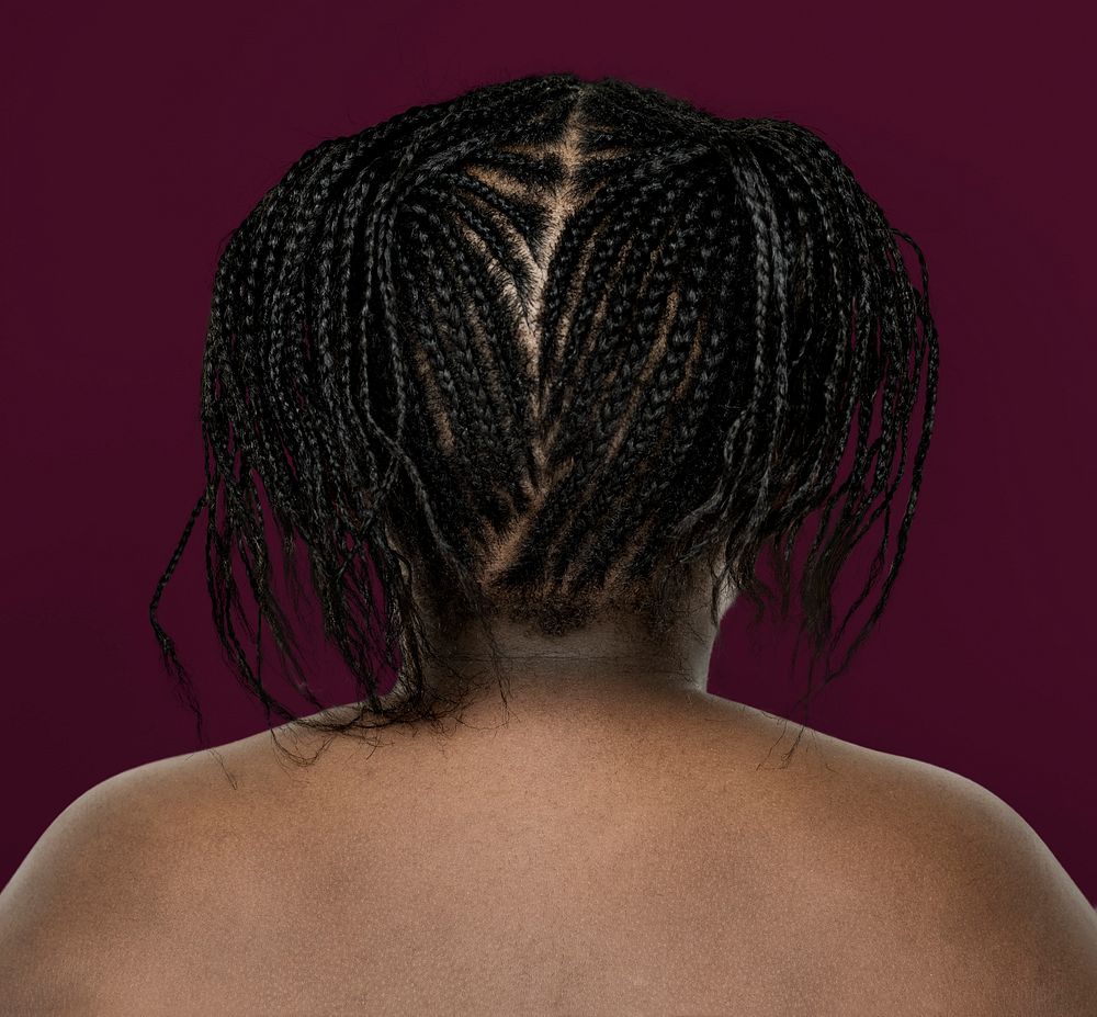 Little african girl shirtless studio portrait in rear view