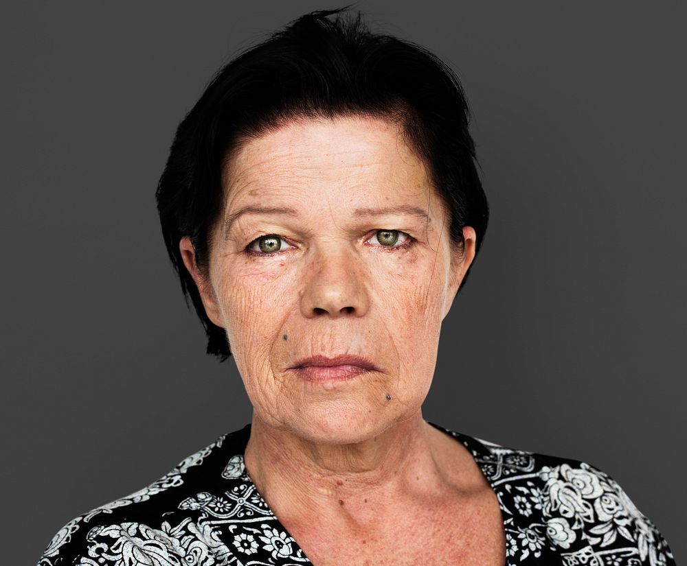 Senior adult woman in moody studio portrait