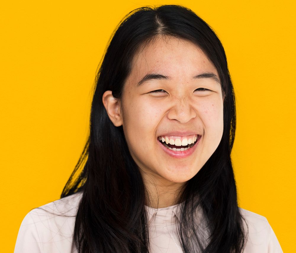Young asian girl smiling studio portrait