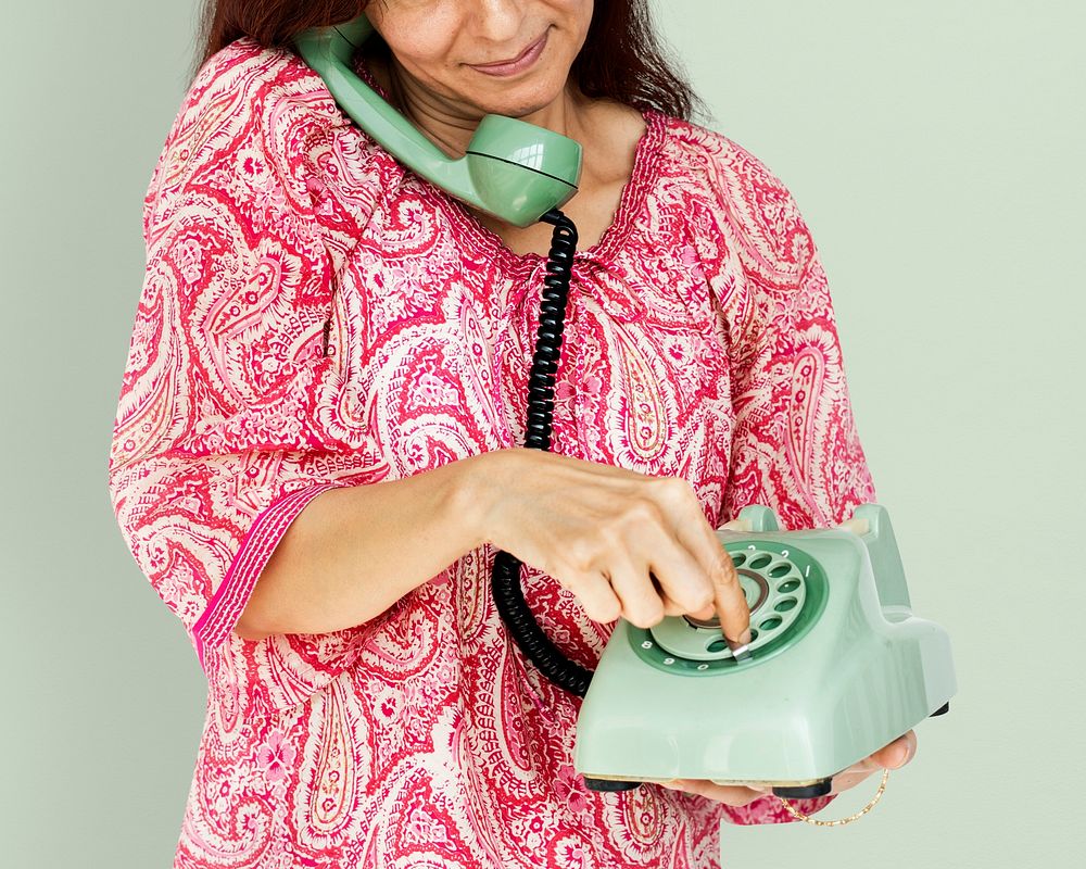 Woman holding and dial telephone communication
