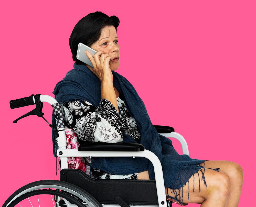 Senior adult woman on wheelchair talking on the phone