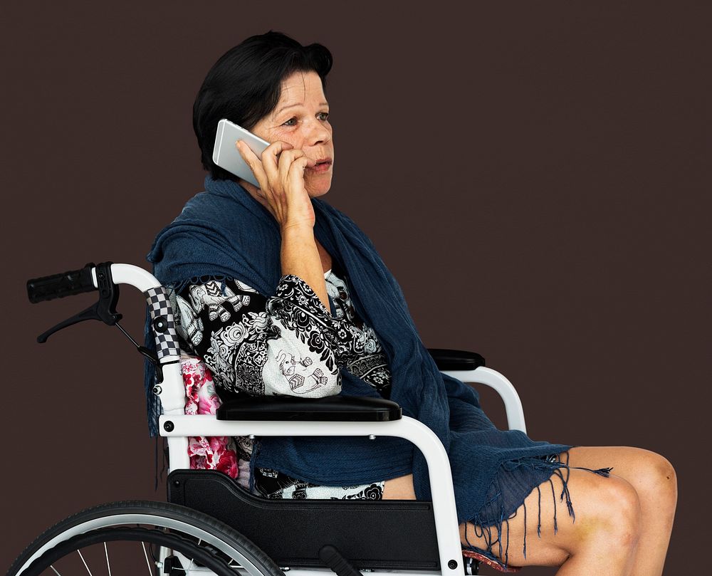 Senior adult woman on wheelchair talking on the phone