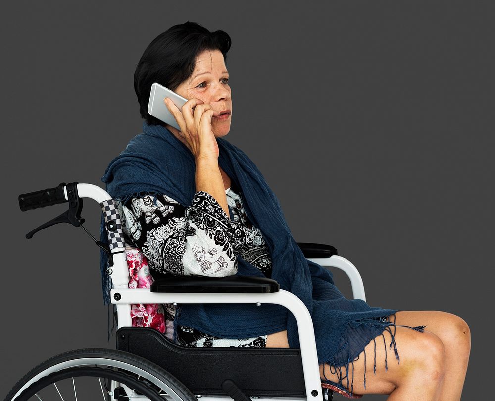 Senior adult woman on wheelchair talking on the phone