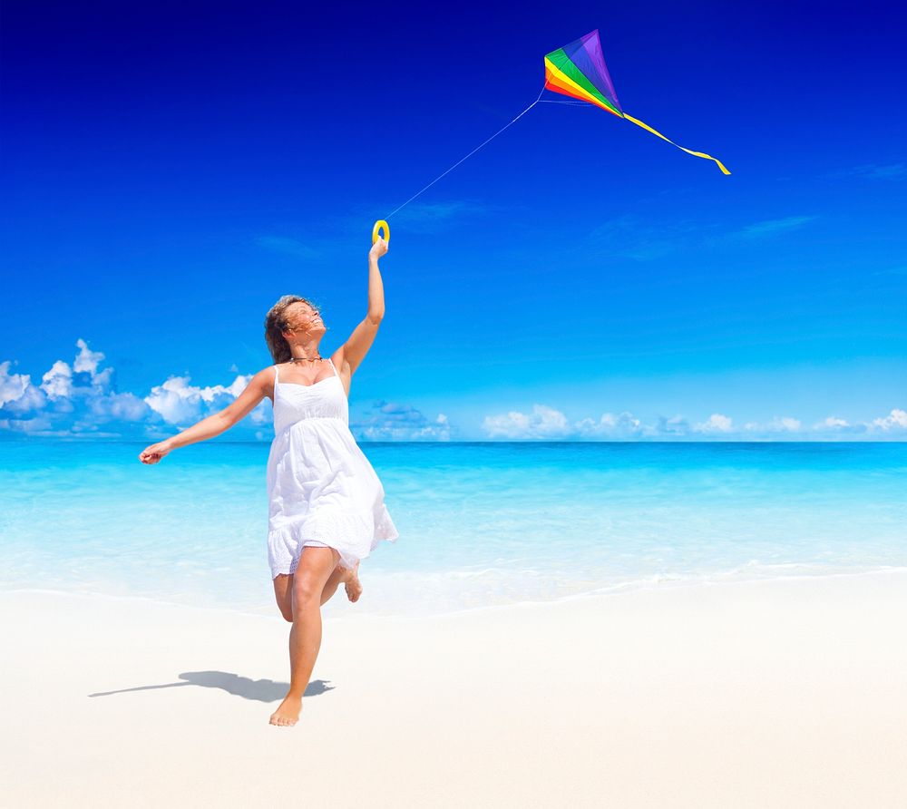 Woman flying a kite on the beach