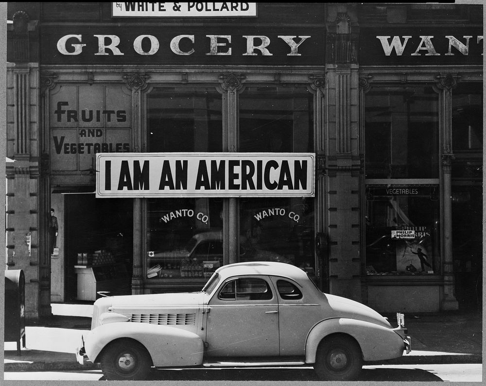 Oakland, Calif., Mar. 1942. A large sign reading "I am an American" placed in the window of a store, at [401 - 403 Eighth]…