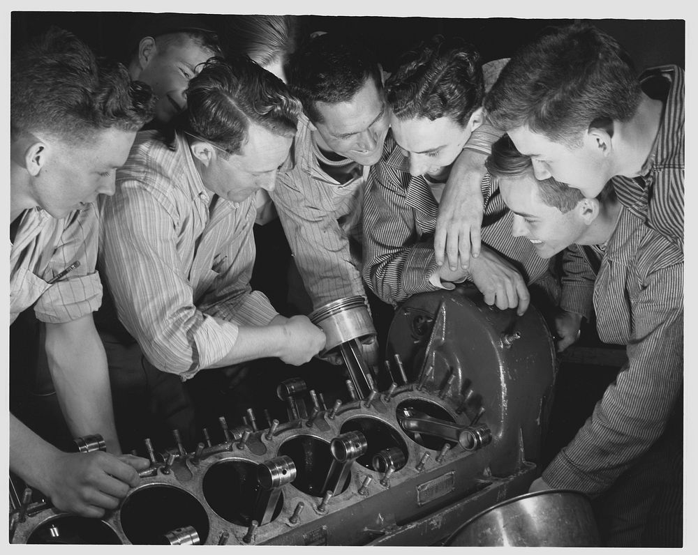 De Land pool. Aircraft construction class. These carefree high school students are learning the serious business of war…