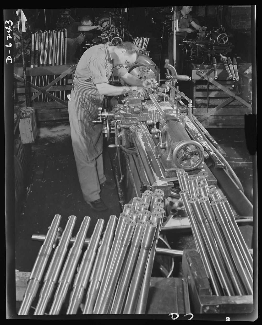 Production. Machine guns of various calibers. Walter Newman, operator of a high-speed lathe in a large firearms plant…