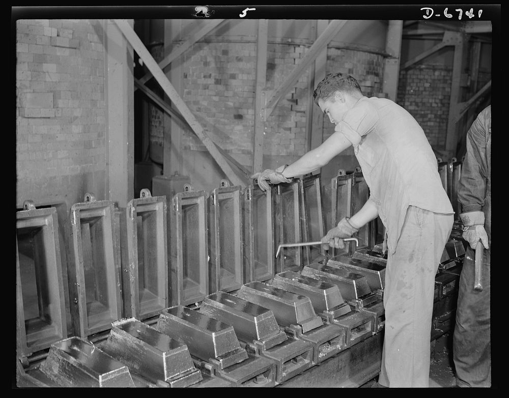 Production. Tin smelting. "Bars" of pure tin are trimmed and cleaned before removal from the molds in which they were formed…