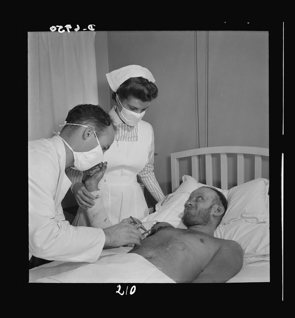 Nurse training. A torpedoed sailor receives burn treatment from a doctor, with student nurse Susan Petty in attendance. Care…