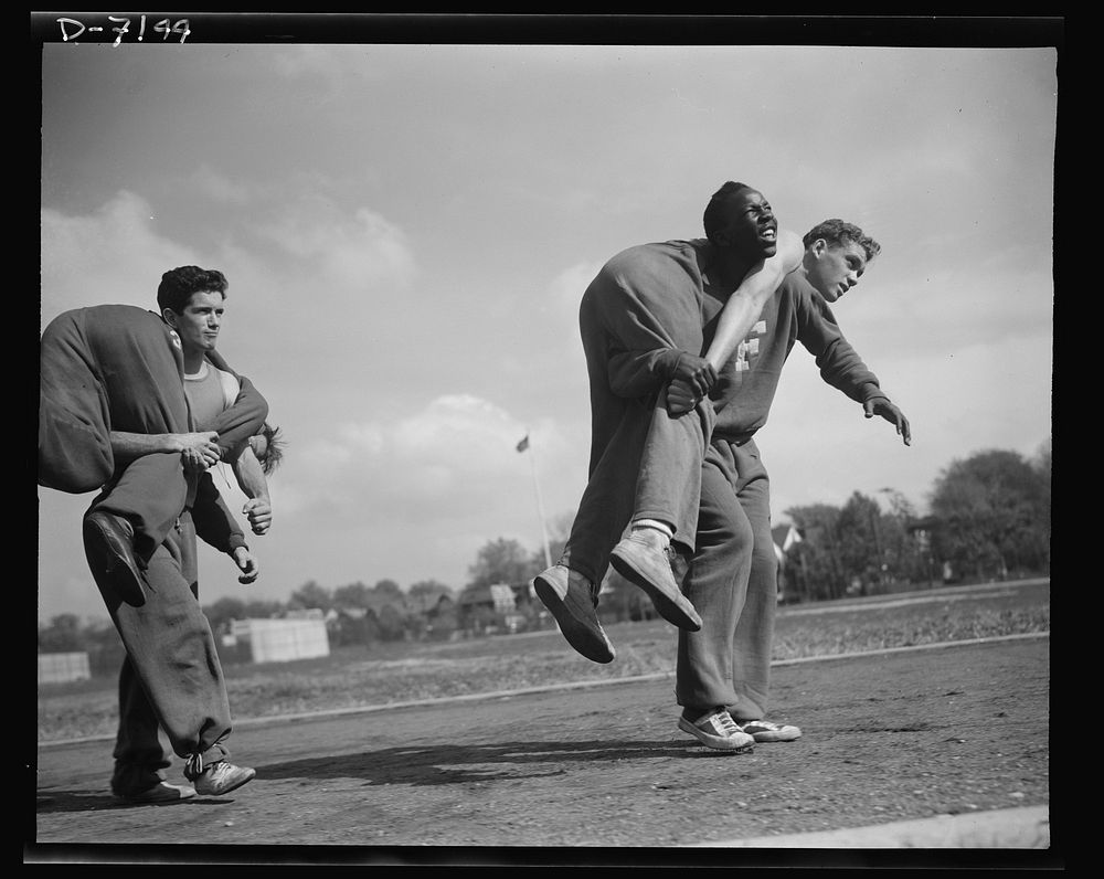 High school Victory Corps. The fireman's "carry." The correct method of carrying a wounded comrade, is shown here by some of…