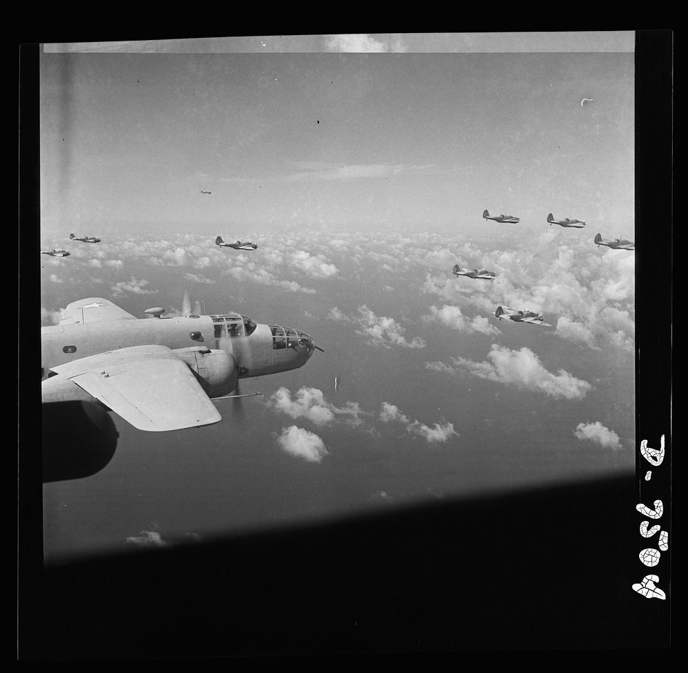 American wings over Africa. A B-25 medium bomber (foreground) is escorted by a group of A-20 light bombers serving as…