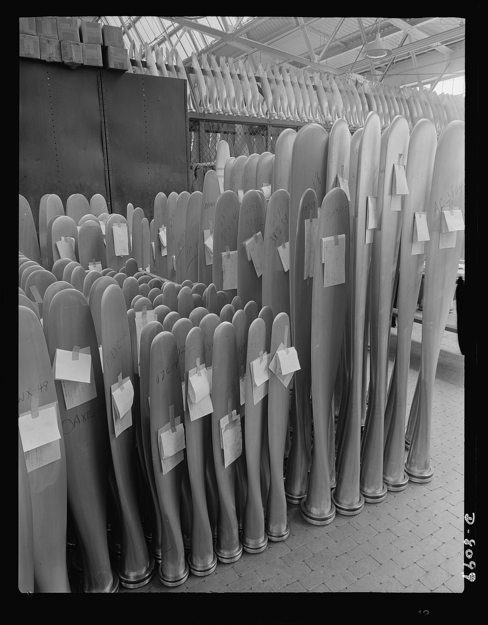 Production. Airplane propellers. Propeller blades that will soon be driving American warplanes are stored after final…