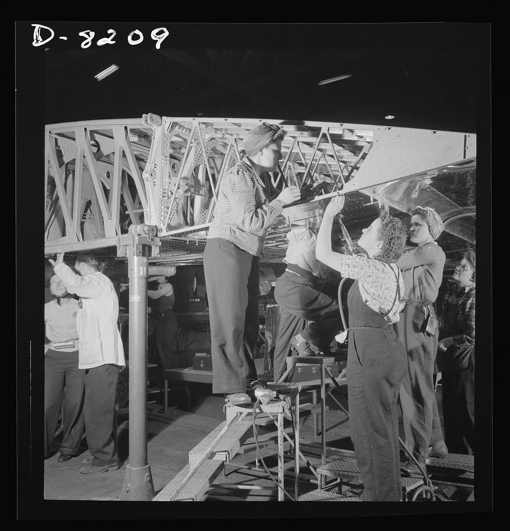 Production. B-17 heavy bomber. Women workers at the Boeing plant in Seattle helps to complete sections which will be added…