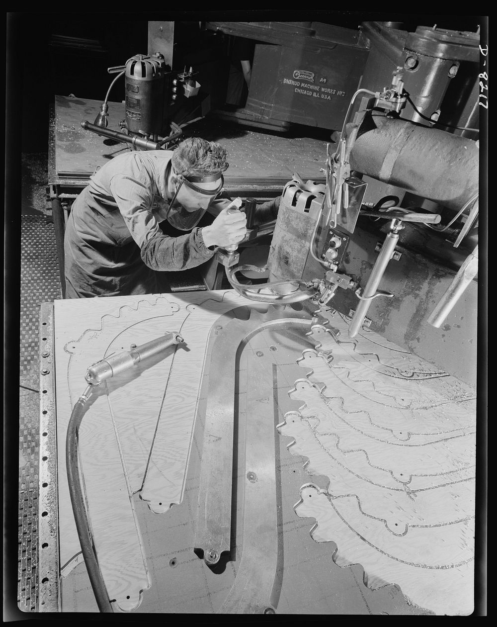 Production. B-17 heavy bomber. Parts for a new B-17F (Flying Fortress) bomber are cut on a routing machine in the Boeing…