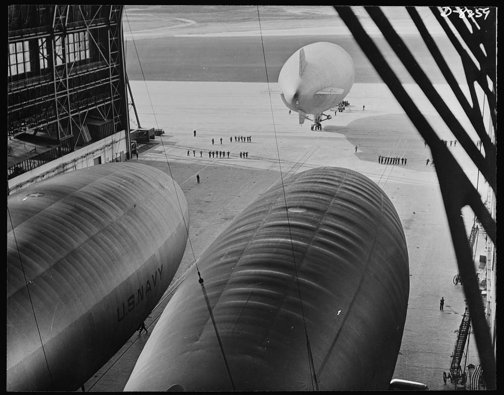 U.S. Navy starts out on patrol duty. A blimp of the U.S. Navy is led onto the apron of an East Coast lighter-than-air…