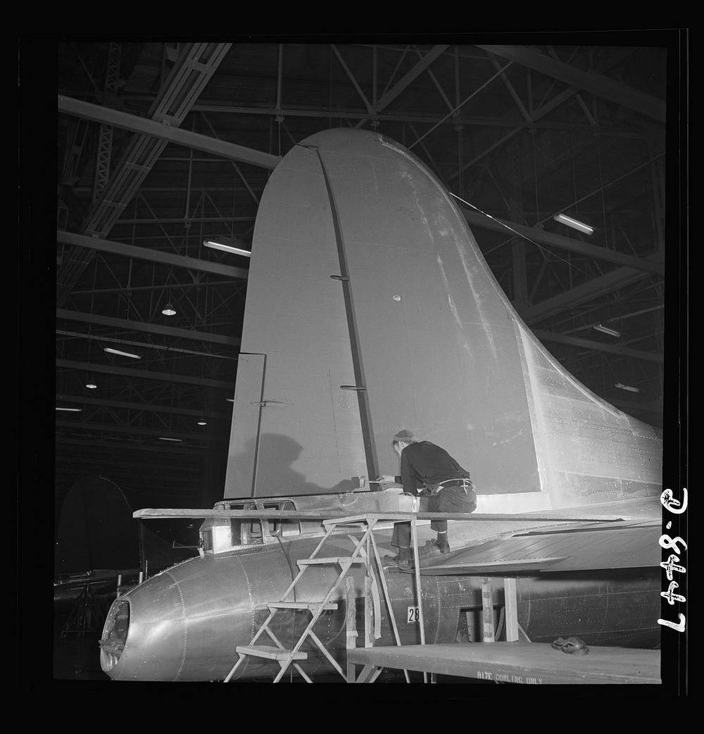 Production. B-17 heavy bomber. The tail and rudder of a mighty B-17F (Flying Fortress) bomber near completion at the Boeing…