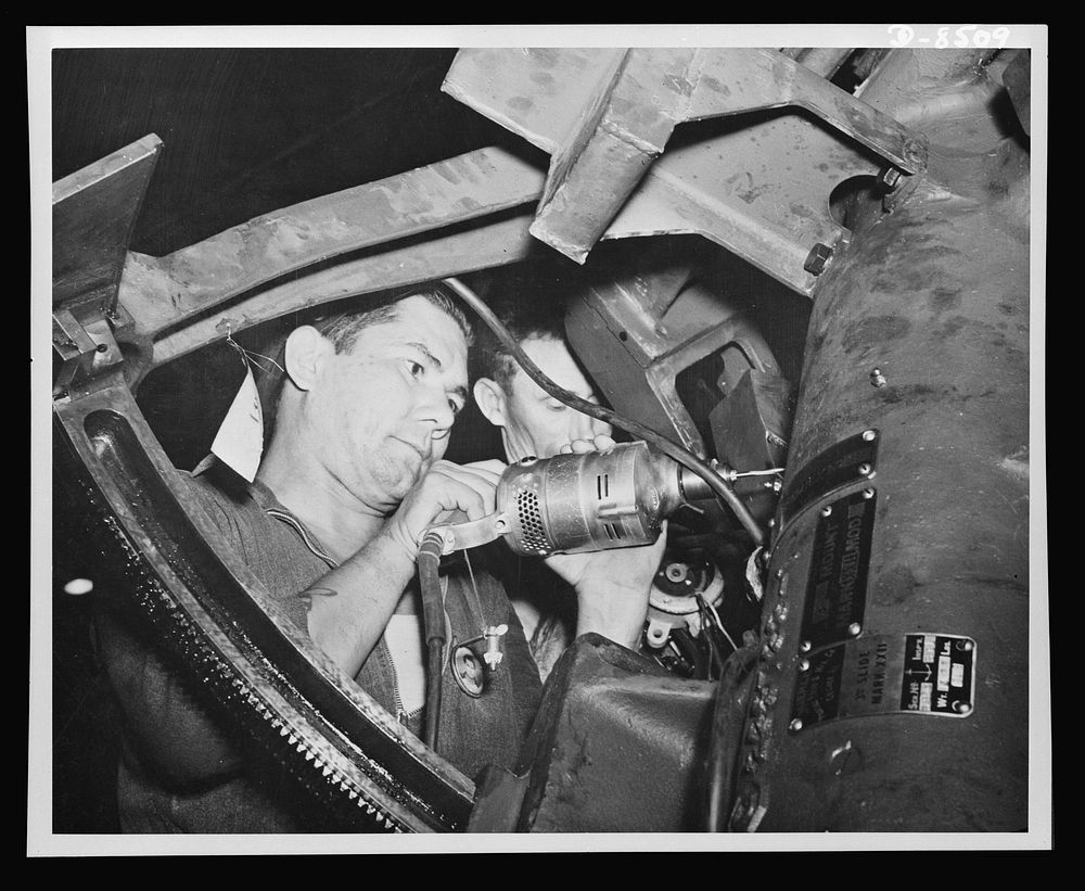 Making ready for the intricate wiring of a ship's gun is shown by Andrew S. Horn, a first class machinist from Ohio.…
