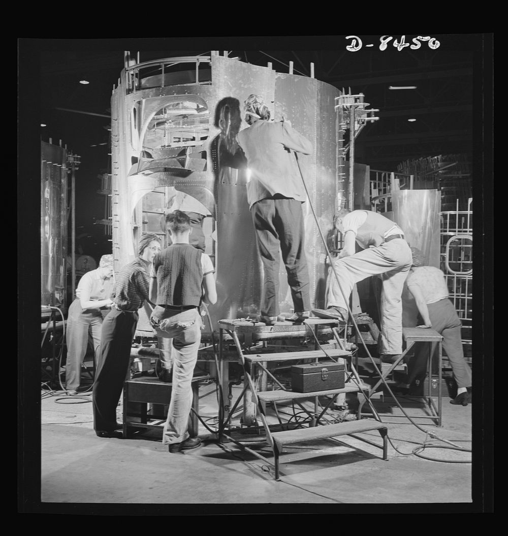 Production. B-17 heavy bomber. A crew of fast, expert workers at the Boeing plant in Seattle rivet a fuselage section for a…