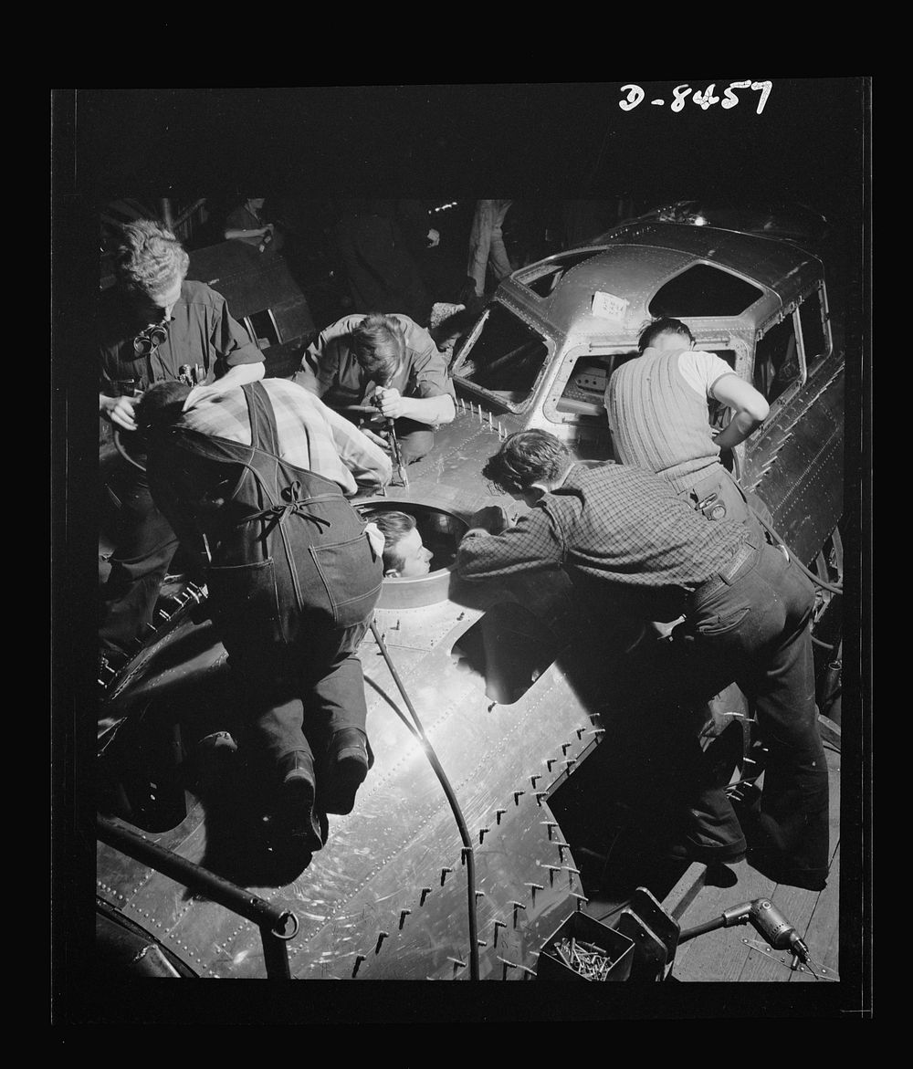 Production. B-17 heavy bomber. Fast, expert workers at the Boeing plant in Seattle apply outer "skins" to fuselage sections…