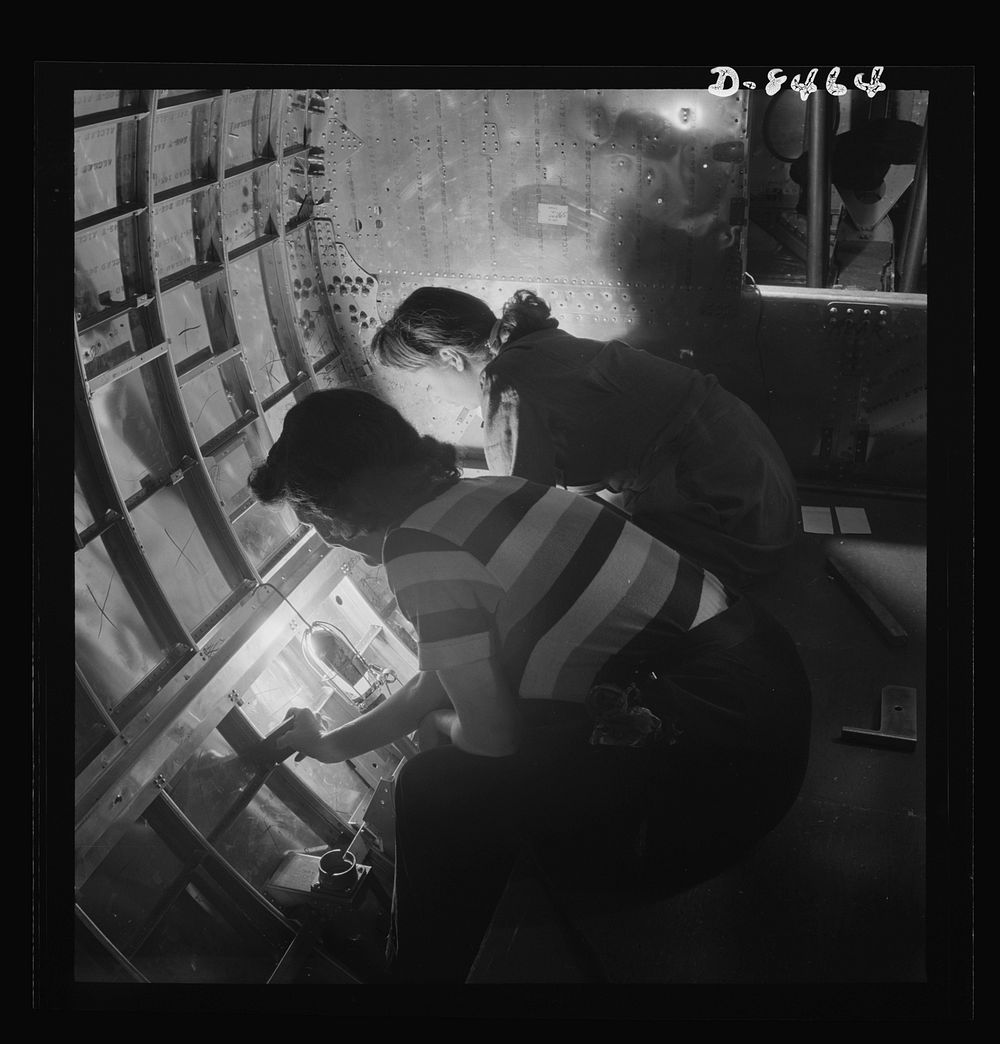 Production. B-17 heavy bomber. Women riveters at the Boeing plant in Seattle work at assembly and fitting operations in the…