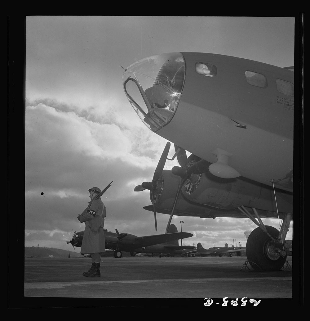 Production. B-17 heavy bomber. An Army sentry guards new B-17F (Flying Fortress) bombers at the airfield of Boeing's Seattle…