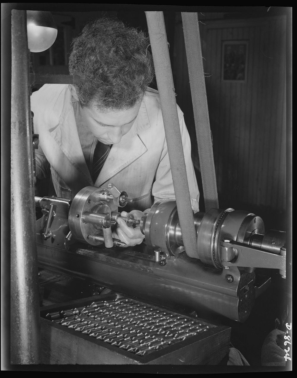 Production. Blood transfusion bottles. In a small plant working under subcontract, John Kerr operates a turret lathe for…