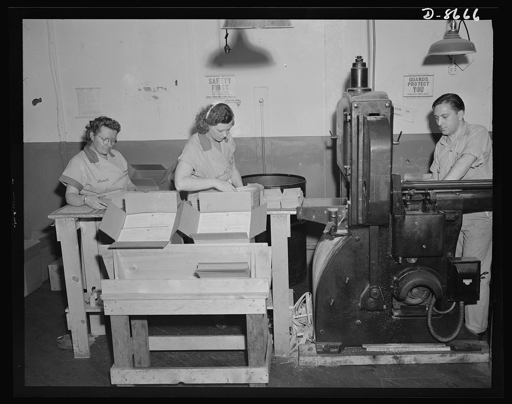 Printing war ration book 2. Glued sheets containing four ration books pass through the cutting machine and come out into…