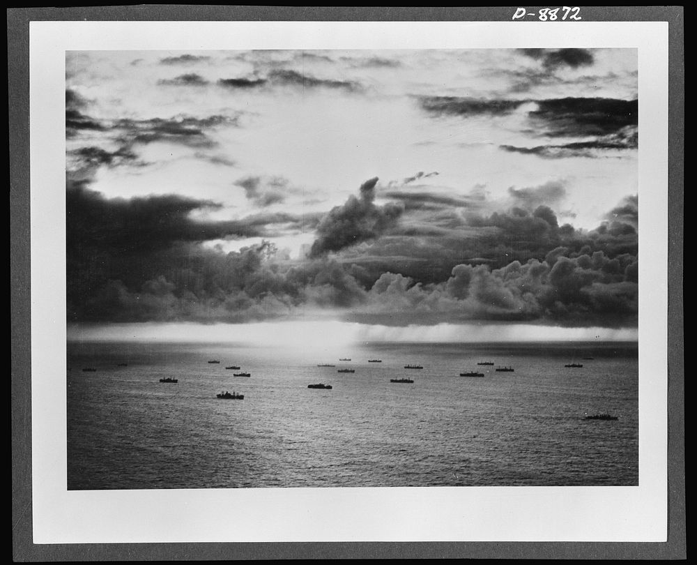 Convoy. Silhouetted against a tropical sky, an American convoy plods steadily across the broad Pacific. Ships like these and…