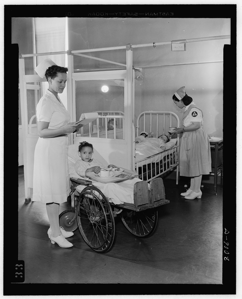 Answering call for volunteer nurses aides. Freedmen's Hospital, Washington, D.C. Senior aide Louise Beleno assists staff…