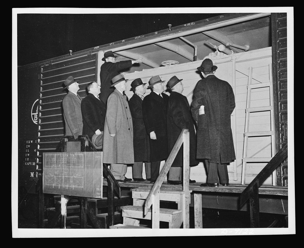 Government and railroad officials inspect the new model boxcar petroleum carrier designed to help the oil shortage in the…