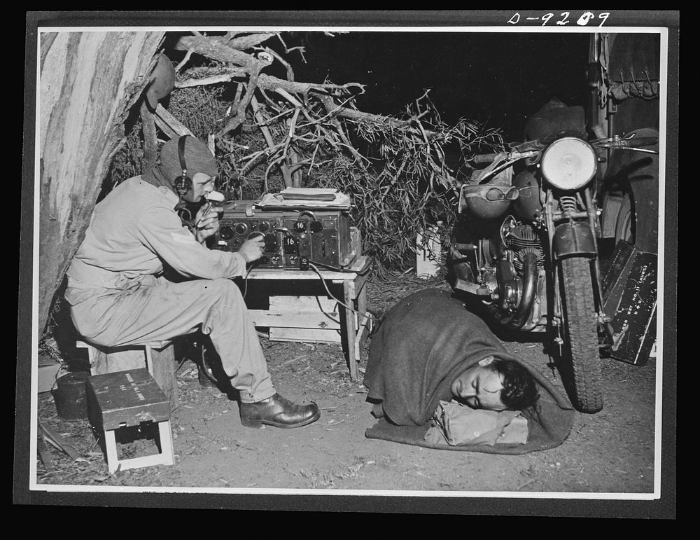 Australia in the war. Australian dispatch riders at unit headquarters sleep beside their American motor, ready to take…