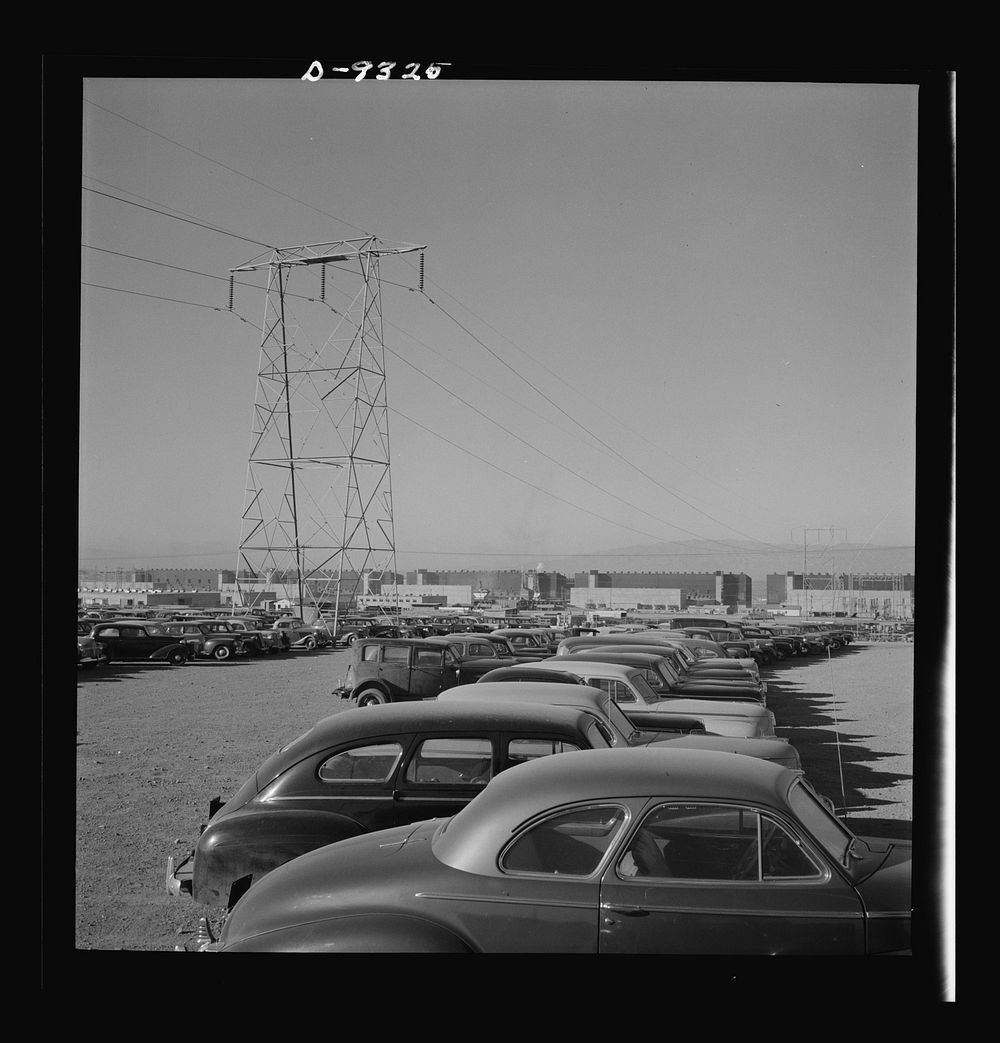 Production. Magnesium. Workers' cars parked under a section of the high-tension transmission lines which bring electrical…