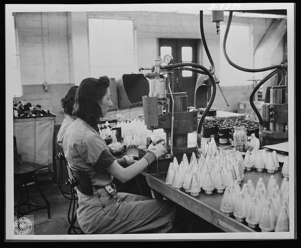 Production. Shell loading. These girls are "staking" fuses in the assembly of artillery shells in a large Midwest loading…