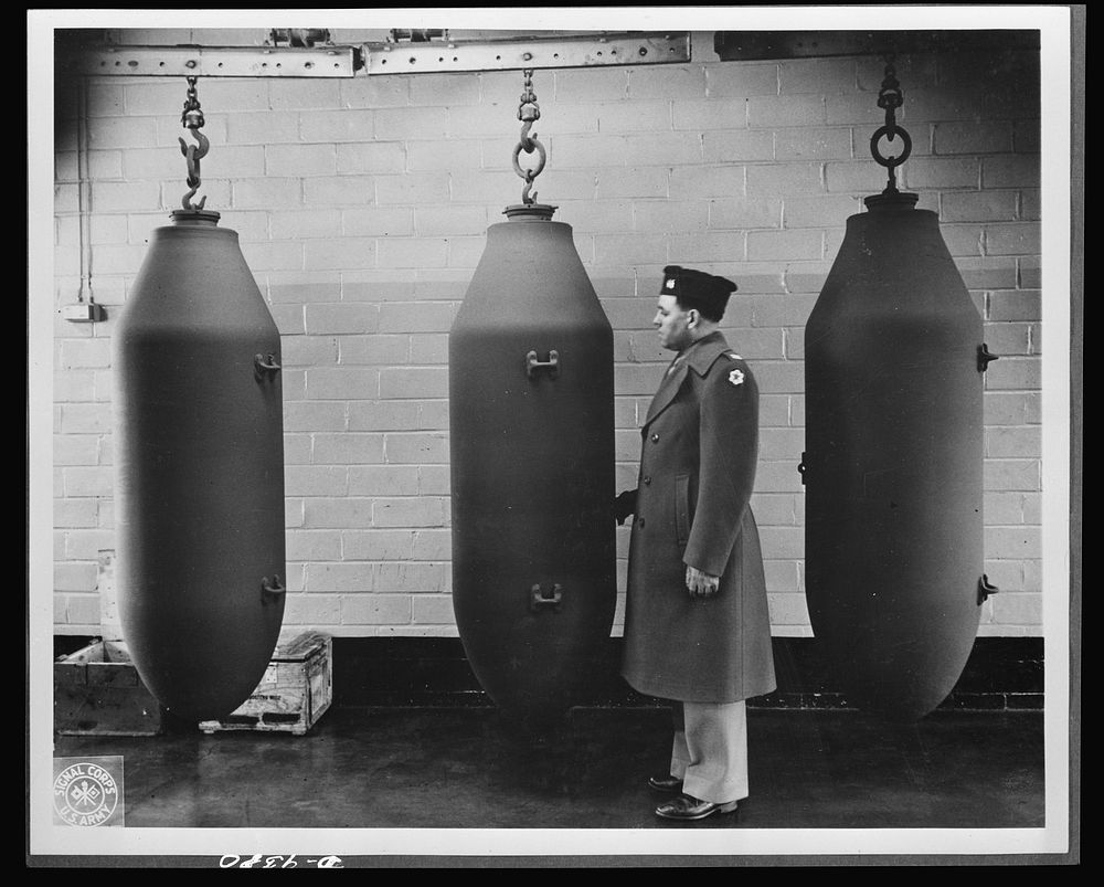 Production. Shell loading. These 2,000-pound bombs will carry death and destruction to the Axis from a huge shell-loading…