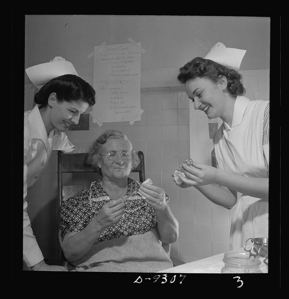 Nurse training. A student nurse (right) instructs a patient in the method of measuring her own insulin dose as a supervisor…