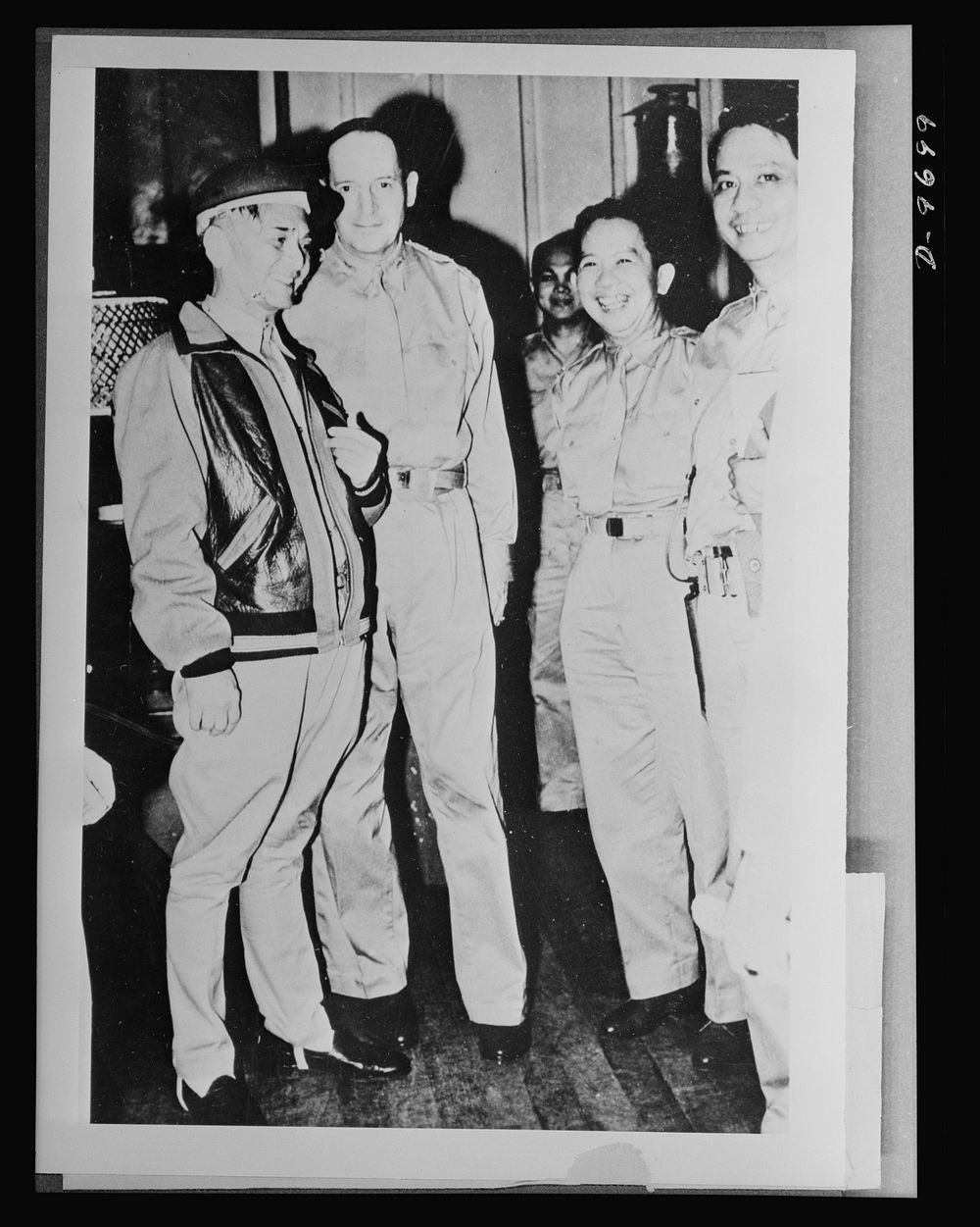 President Manuel L. Quezon is shown conferring with General Douglas MacArthur and members of his staff, during the fighting…