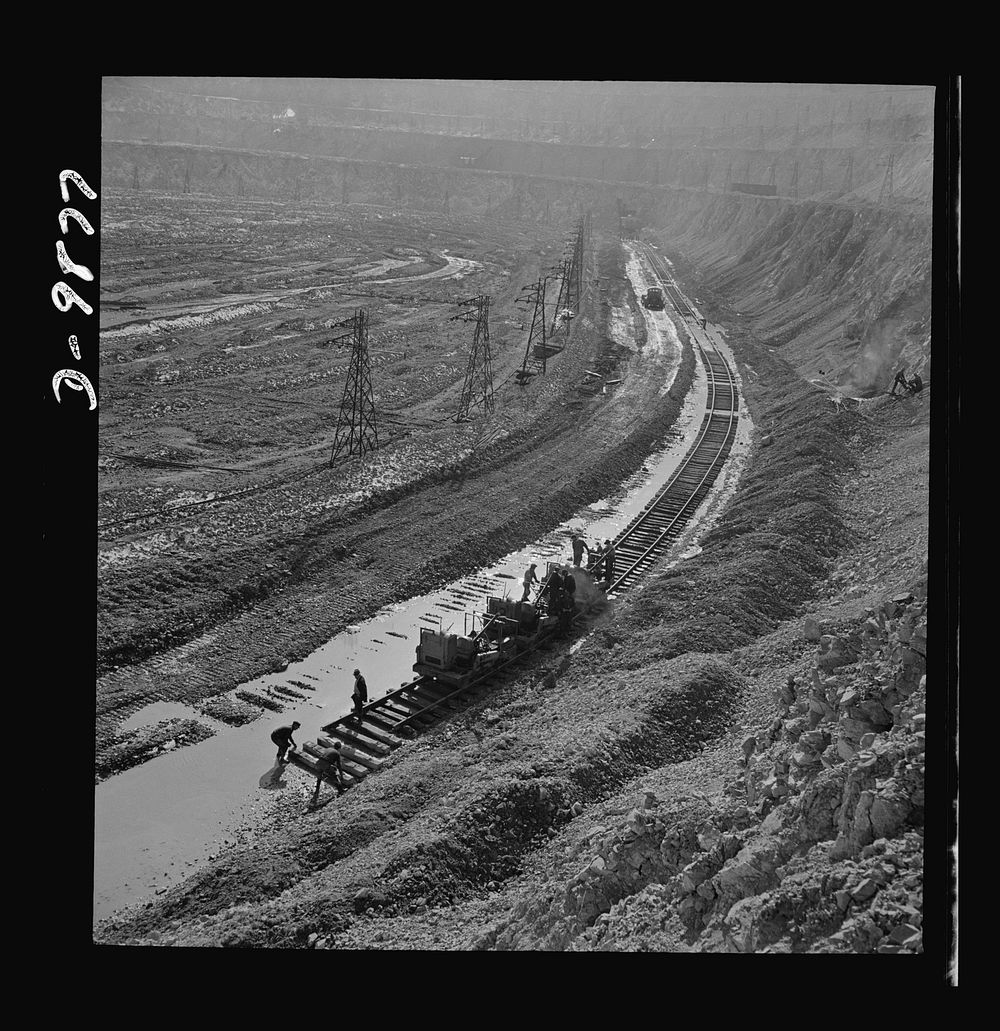 Utah Copper: Bingham Mine. Track-laying crew at open-pit mining operations of Utah Copper Company at Bingham Canyon, Utah.…