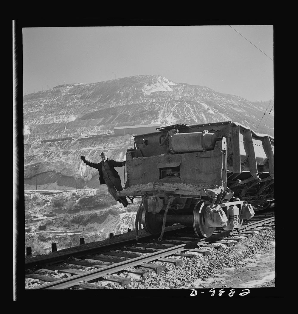 Utah Copper: Bingham Mine. Brakeman of an ore train at the open-pit mining operations of Utah Copper Company, at Bingham…
