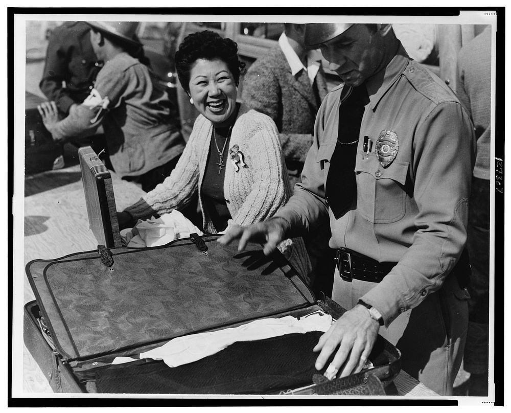 Japanese relocation, California. All baggage is inspected before newcomers enter the Santa Anita Park Assembly Center at…