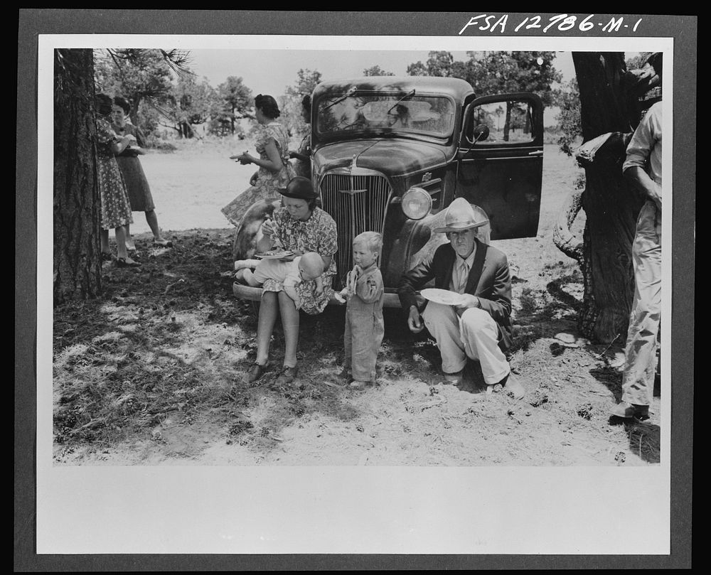 Farm folks eating dinner at the all-day community sing. Pie Town, New Mexico by Russell Lee